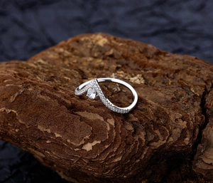 Detailed macro view of S925 silver V-shaped ring with pear-cut drop stone and pavé gems