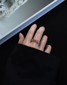 Detailed view of baguette-cut rainbow zircon stones on a gold plated S925 silver ring