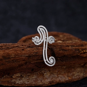 S925 sterling silver swirl ring with pavé stones on a dark wood and black background