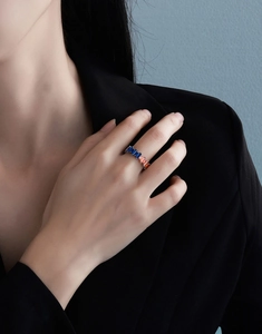 Close-up of S925 silver ring with alternating blue and orange rectangular zircon stones