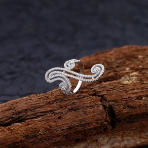 Exaggerated S925 sterling silver swirl ring with paved white zircon on aged wood background