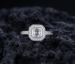 Macro shot of S925 sterling silver ring featuring square halo setting on dark volcanic rock