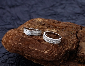 Macro shot of S925 sterling silver stacking rings with sparkling zircon on wood bark