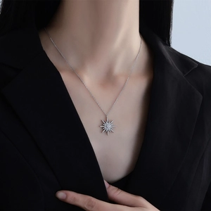 Elegant S925 sterling silver starburst pendant necklace with white zircons for women
