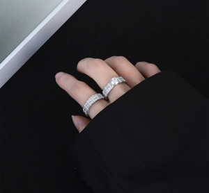 Detail of stacked S925 sterling silver rings with brilliant zirconia on a hand
