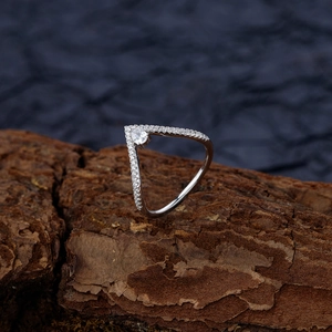 V-shaped S925 silver ring with a pear-cut drop stone and pavé diamonds on textured bark