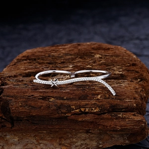 Original S925 sterling silver double-finger ring with pavé zircons on a wooden base