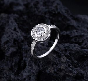 Macro shot of S925 sterling silver ring with large round zircon and halo diamond setting