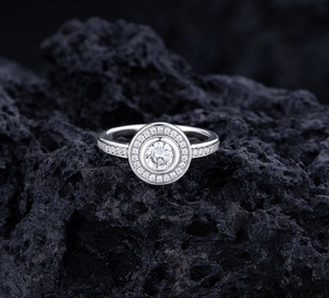 Macro view of S925 sterling silver ring with halo pavé diamonds on black volcanic rock