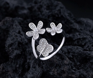 Macro view of sterling silver adjustable ring with zircon flower and butterfly details
