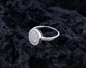 Macro shot of S925 sterling silver pave ring with sparkling stones on volcanic rock