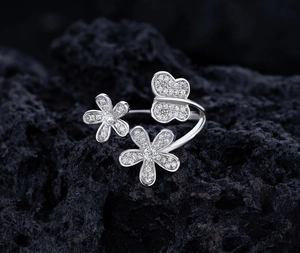 Macro shot of silver petal and butterfly ring with sparkling pavé-set crystals
