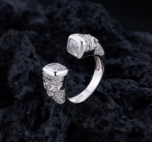 Macro shot of S925 sterling silver ring with large square diamond on black rock