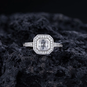 Luxe S925 sterling silver emerald-cut halo ring with micro-pave diamonds on black rock
