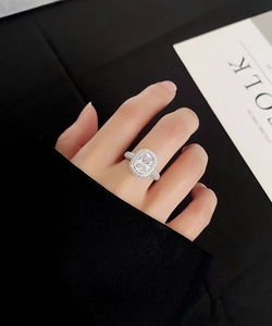 Detail of a square-cut radiant S925 silver ring with pavé setting worn on finger