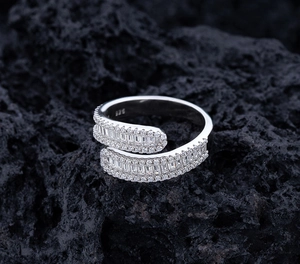 Macro shot of 925 silver crossover ring featuring baguette and round zirconia stones