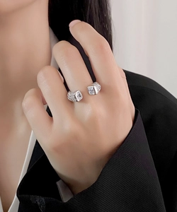 Detail of adjustable S925 silver ring with irregular texture and square zircon on hand