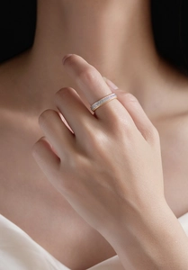 Detail view of gold-plated twisted rope edge and micro-set diamond ring on model