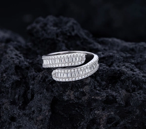 Macro shot of silver S925 cross ring featuring square and round cut clear diamonds