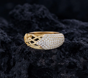 Macro shot of gold-plated silver ring with micro-pave diamonds on black rock