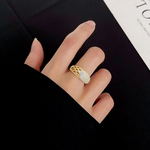 Detail of gold mesh ring with micro-pave white zircons on a hand-worn model