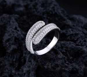 Macro detail of crisscross S925 silver ring with baguette and round cut diamonds
