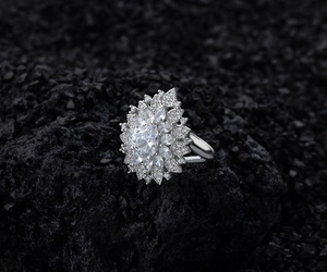Macro shot of silver pear-shaped flower cluster ring with pavé AAA zirconia stones