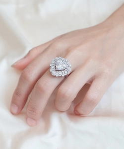 Detailed view of heart-shaped diamond ring with double halo on silver band