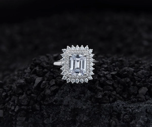 Macro shot of an emerald-cut simulated diamond ring with a double halo setting