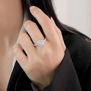 Sparkling S925 sterling silver halo ring with pave-set diamonds on a female hand