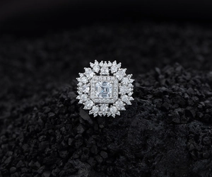 Macro view of S925 sterling silver ring with emerald cut center stone and halo diamonds