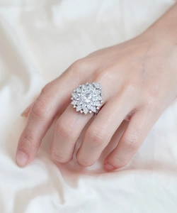 Detailed view of luxury pear-cut cluster ring with dazzling stones on silk background