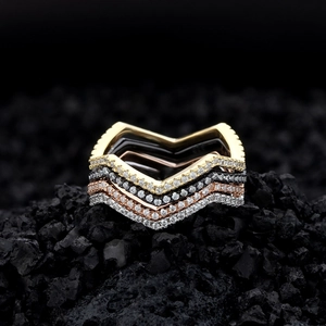 Set of four minimalist V-shaped chevron stacking rings in gold silver and rose gold