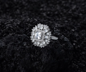 Macro shot of S925 sterling silver ring featuring a square cut stone with double halo