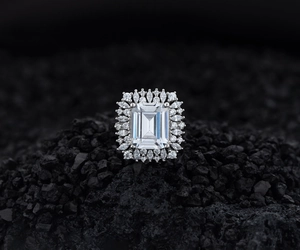 Macro detail of emerald cut silver ring with pavé diamonds on dark volcanic stones