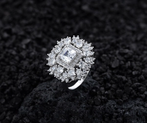 Macro shot of S925 silver ring featuring a tiered cluster of brilliant square cut stones