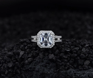 Macro shot of S925 silver ring featuring a radiant cut square diamond on black stones