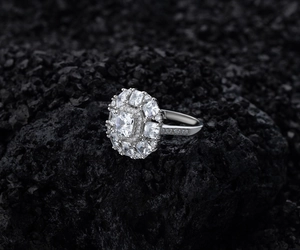 Close-up of S925 silver ring featuring square clustered diamonds on dark textured rock