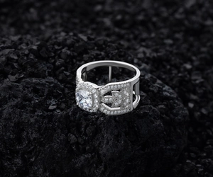 Detailed macro shot of vintage leaf hollow ring with cushion-cut zircon on volcanic rock