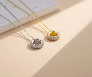 Detail shot of gold and silver circle pendants with paved crystals on shimmering chains