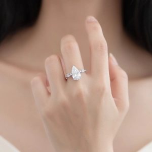 Pear cut teardrop simulated diamond ring in sterling silver with pave set side stones