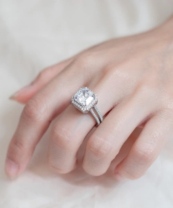 Macro shot of S925 sterling silver ring with emerald cut diamond in halo setting
