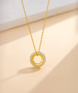 Macro shot of gold-plated silver round pendant with three rows of pavé pavé-set zircons