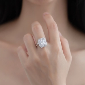 Elegant emerald cut cubic zirconia ring with double halo setting on woman finger