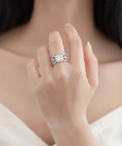 Detailed view of leaf lace hollow silver ring with halo round cut diamond and pave accents