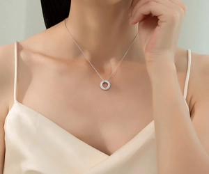 Close-up of S925 sterling silver pave circle necklace on model for elegant look