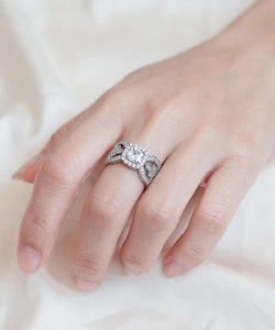 Macro shot of silver sterling ring with square halo diamond and pavé crisscross band