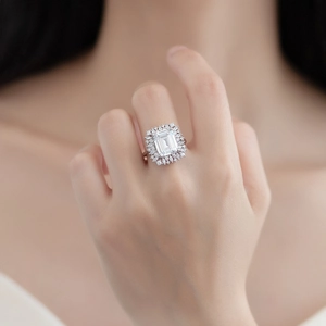 Elegant emerald cut sparkling ring with a floral halo on a silver band for women