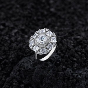Elegant square-cut silver ring with shimmering diamonds on a dark volcanic rock base