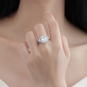 Elegant 925 sterling silver emerald cut halo ring with side trapezoid diamonds on finger